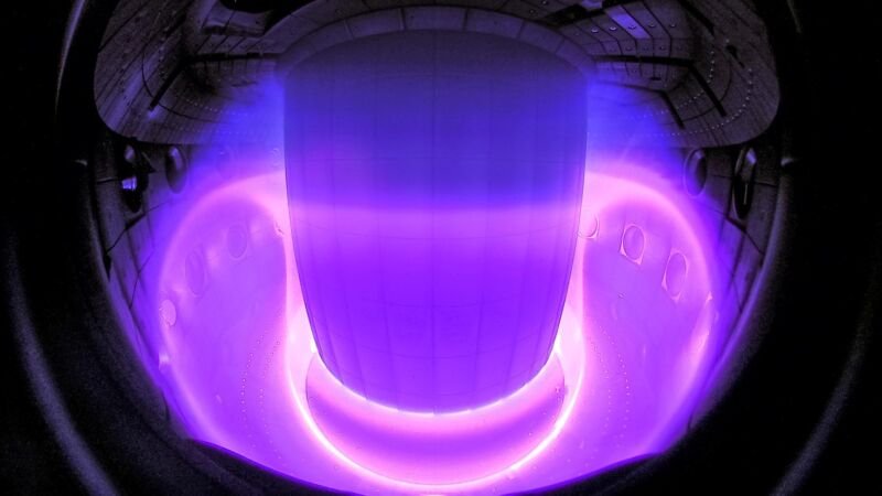 Dernier succès du groupe d'IA de Google : contrôler un réacteur à fusion 1 Un espace sombre avec un matériau toroïdal qui brille en violet.
