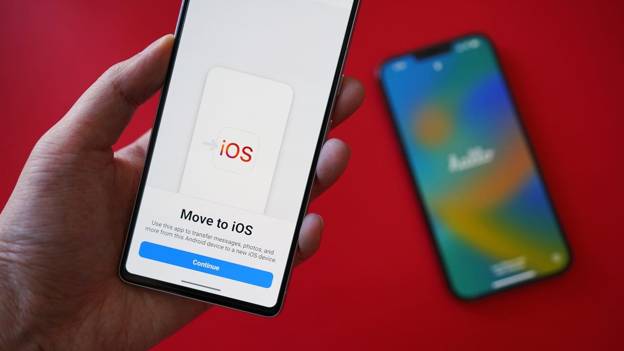 Main tenant un téléphone indiquant Passer à iOS, avec un autre téléphone en arrière-plan