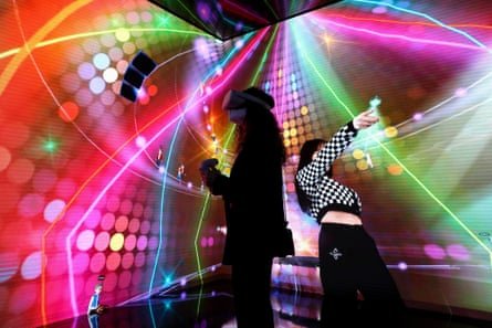 A visitor to this years Mobile World Congress Barcelona wearing a VR headset to take part in a virtual concert.