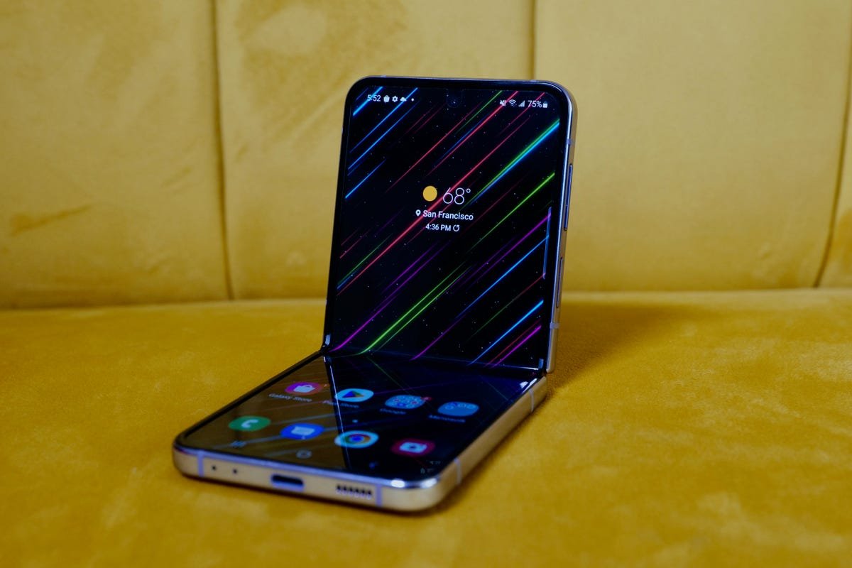 8 Most Impressive Phones Rumored for 2023 8 The Galaxy Z Flip 4 in Flex Mode on a yellow couch