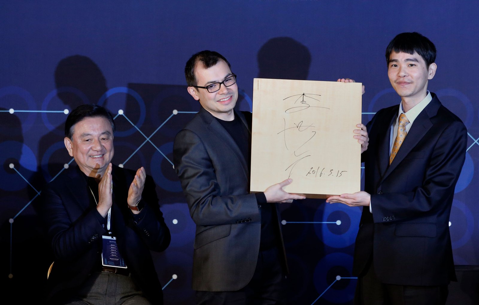 Hassabis celebrates DeepMinds victory over Go player Lee Sedol, right, in South Korea in 2016 (Lee Jin-manAP)