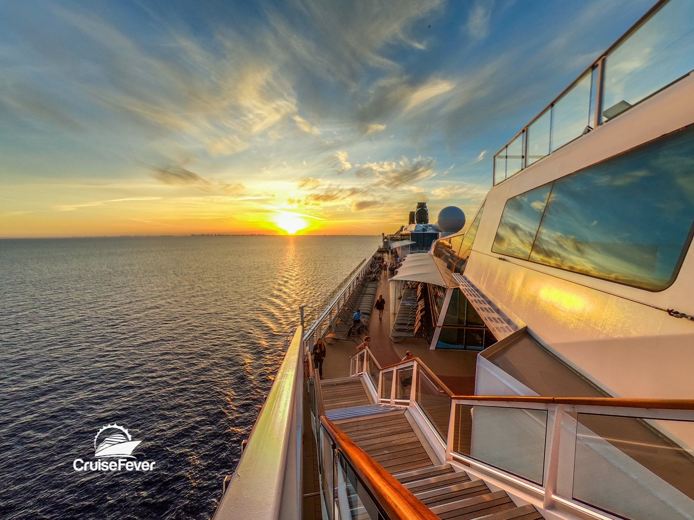 celebrity cruise ship on outside deck at sunset over water