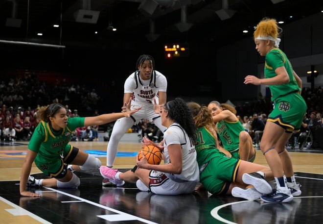 Nov 6, 2023; Paris, FRANCE; South Carolina Gamecocks center Kamilla Cardoso (10) tries to control a ball on the floor against Notre Dame Fighting Irish guard Cassandre Prosper (4) and Notre Dame Fighting Irish forward Maddy Westbeld (21) in a women's college basketball game at Halles Georges Arena. Mandatory Credit: Stephane Mantey/Presse Sports via USA TODAY Sports