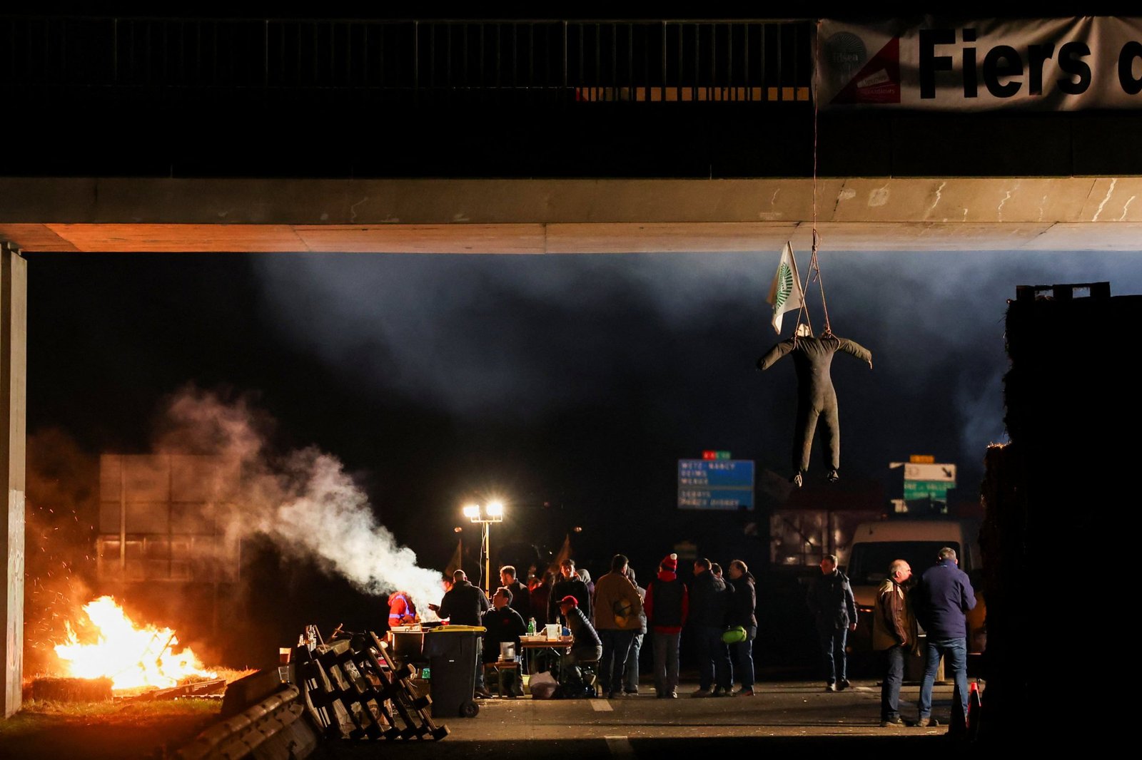 An effigy hangs near people gathering during a blockade by farmers in Jossigny, near Paris. Photo: Reuters