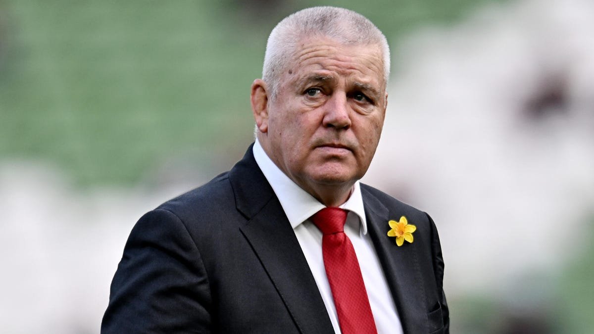 Warren Gatland, entraîneur-chef du rugby du pays de Galles, porte un costume avec une cravate rouge et un insigne de fleur de jonquille.
