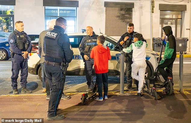 Police quiz two 12-year-old boys on scooters on the streets of Beziers, France, after midnight.The boys were taken to the police HQ and at 2am their parents collected them
