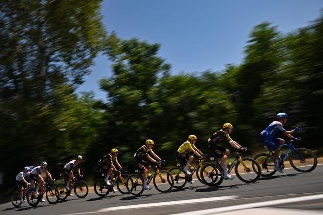 Le coureur danois de Jumbo-Visma, Jonas Vingegaard, porte le maillot jaune (3e R) de leader du classement général lors de la 18e étape de la 110e édition du Tour de France cycliste dans les Alpes françaises le 20 juillet 2023. (Photo de Marco BERTORELLO / AFP )