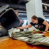 Elections workers empty a bin to count postal ballots for the European Union elections in Frankfurt, Germany, on Sunday, June 9, 2024.